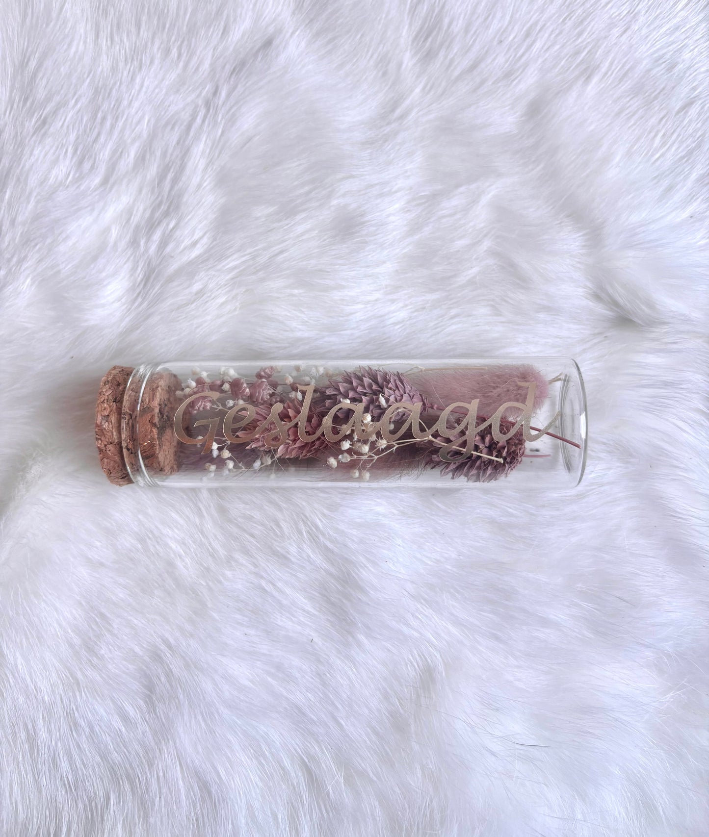 OK - Glazen buisje met kurk
oudroze en witte droogbloemen
Tekst: geslaagd goud
B 10cm 
D 3cm
Prijs: €5,50
Voorraad: 1